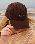 STATUS ANXIETY UNDER THE SUN CAP